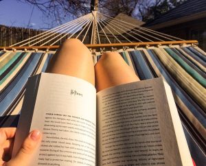 mujer leyendo un libro al aire libre